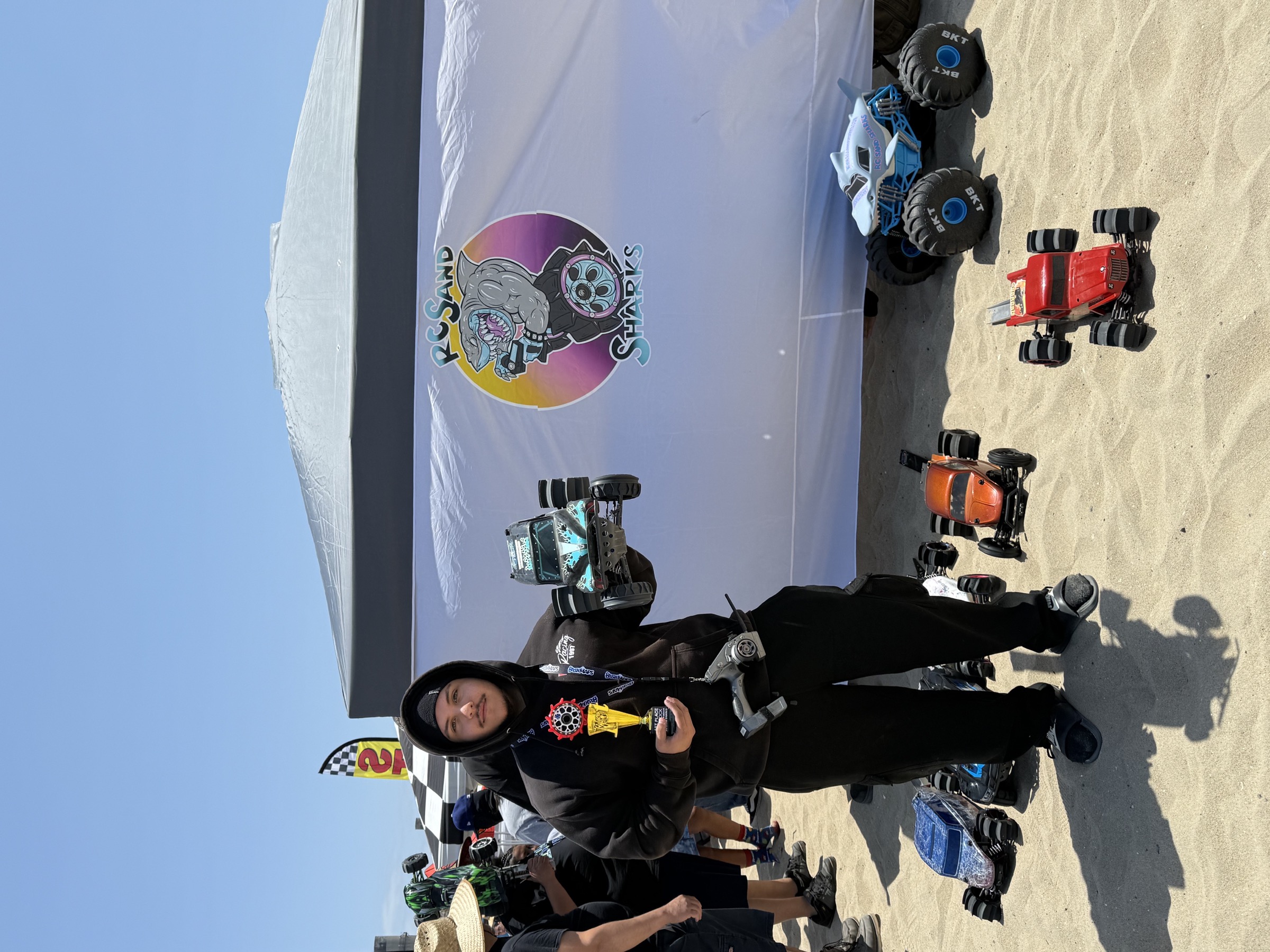 RC Sand Sharks racer with trophy and RC cars